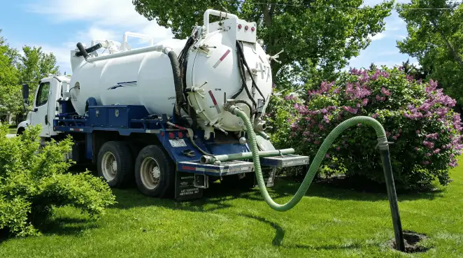 Professional vacuum truck performing residential drainage and septic maintenance in Jackson, MS