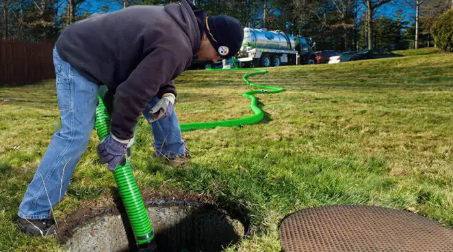 Service technician performing residential septic pumping and drainage maintenance in Jackson, MS